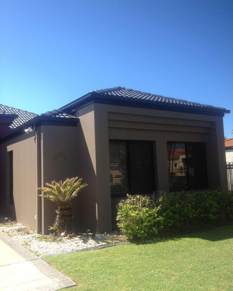 Modern home exterior painted in dark charcoal