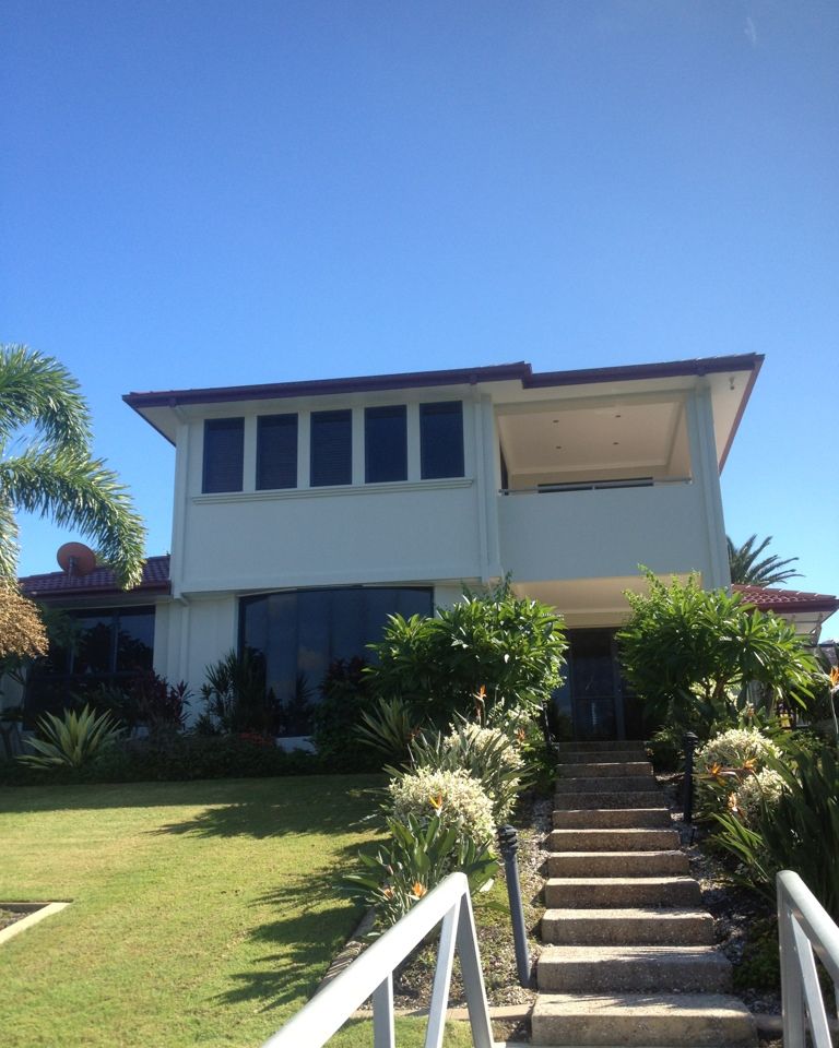 Two-storey home exterior repaint in white
