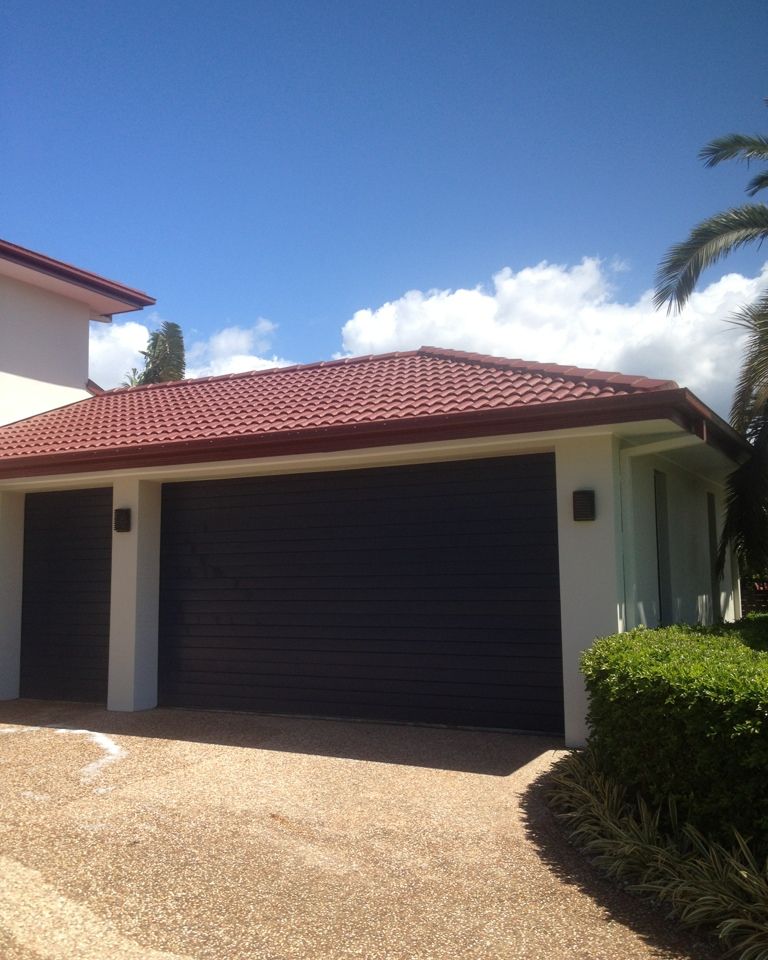 Rendered home and garage repainted under a red tile roof