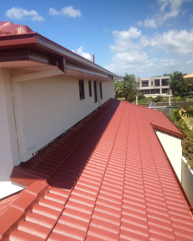 Restored red tile roof with new ridge capping